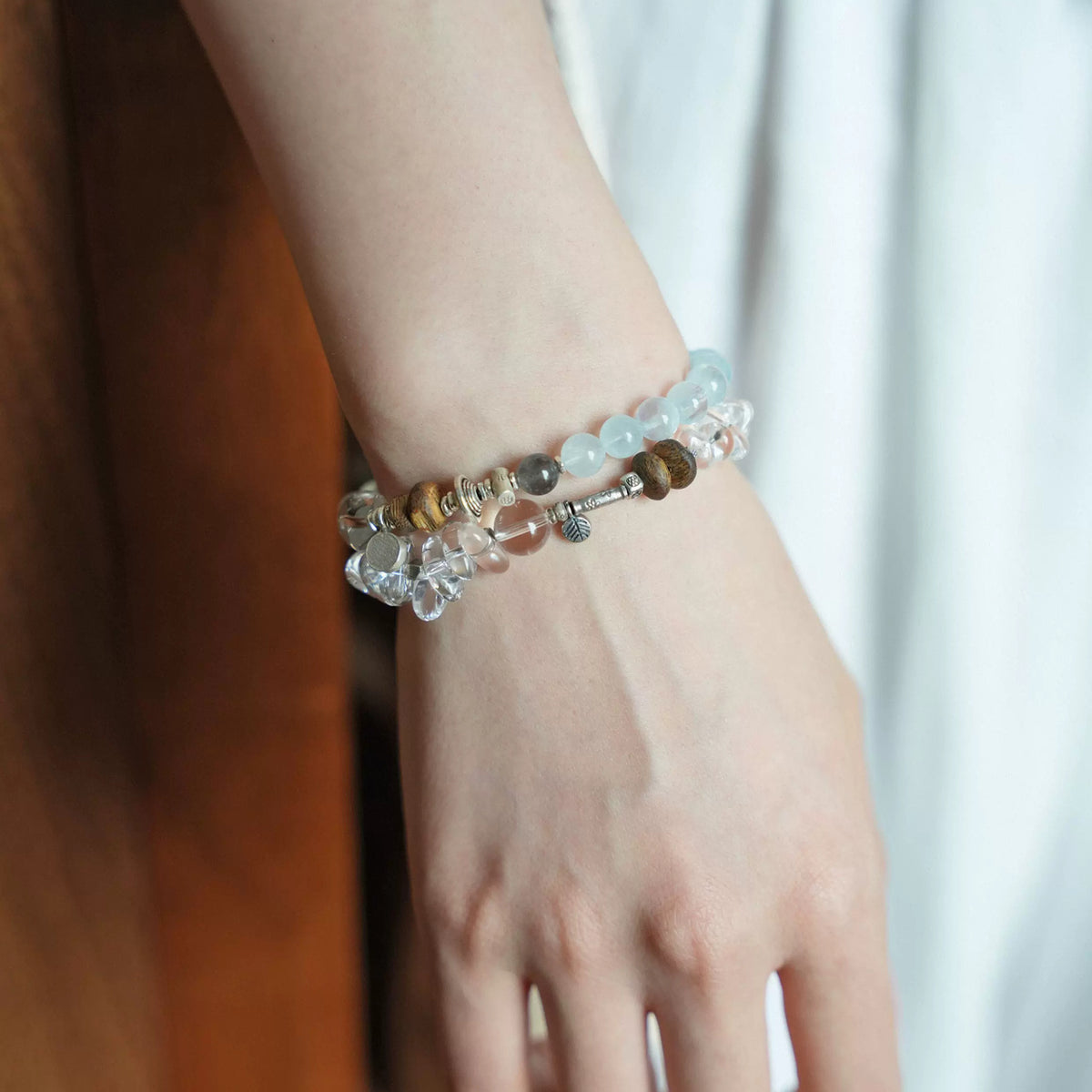 Pine clear quartz bracelet without silver-tone cube worn on the wrist