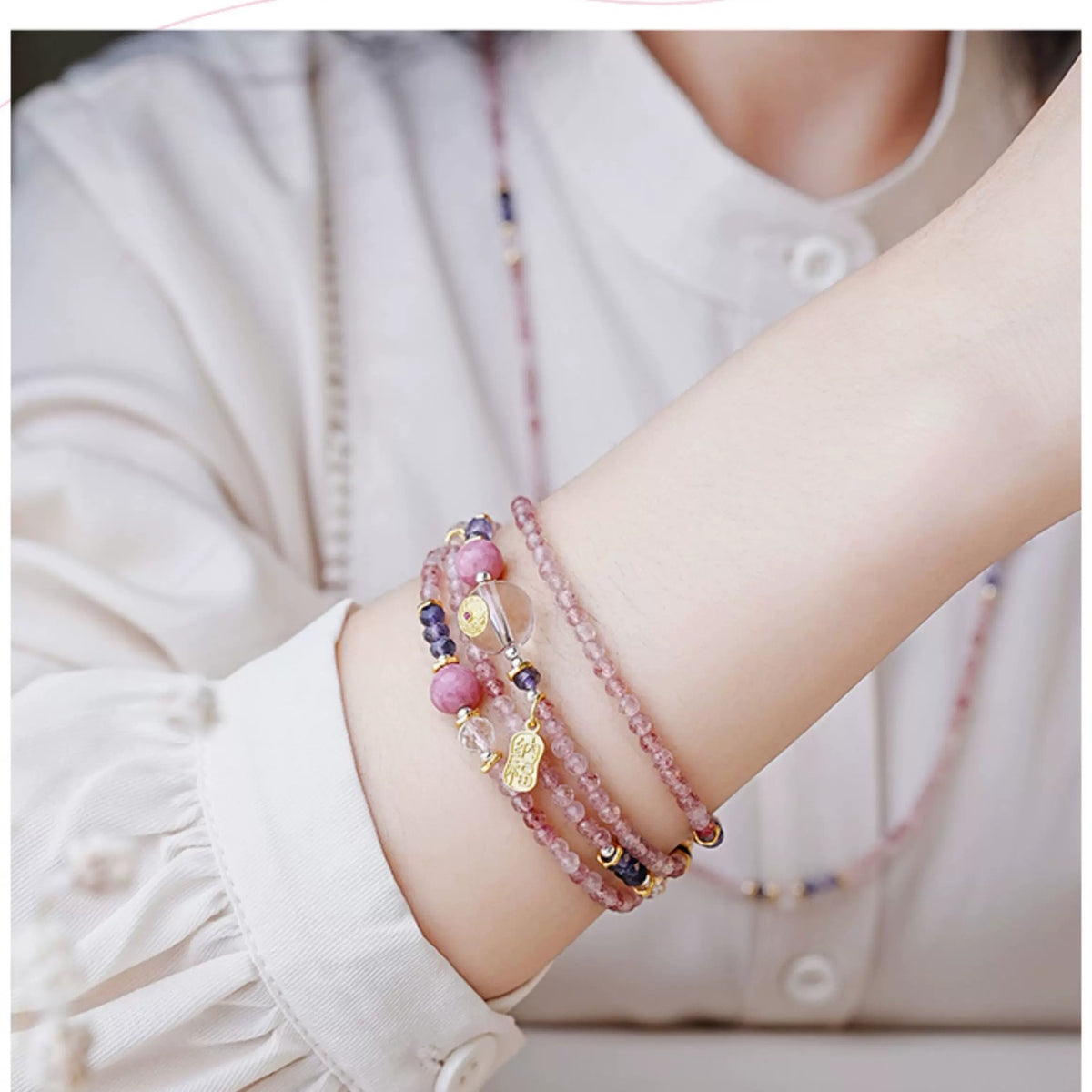 Model wearing the Peach Fortune strand as a multi-wrap bracelet