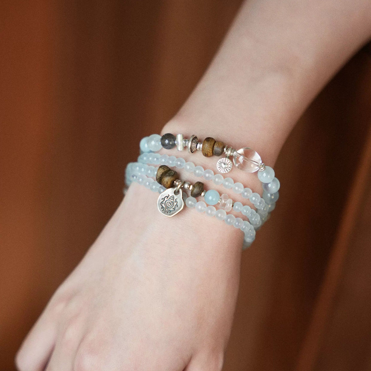 Dawn aquamarine three-wrap bracelet worn on wrist