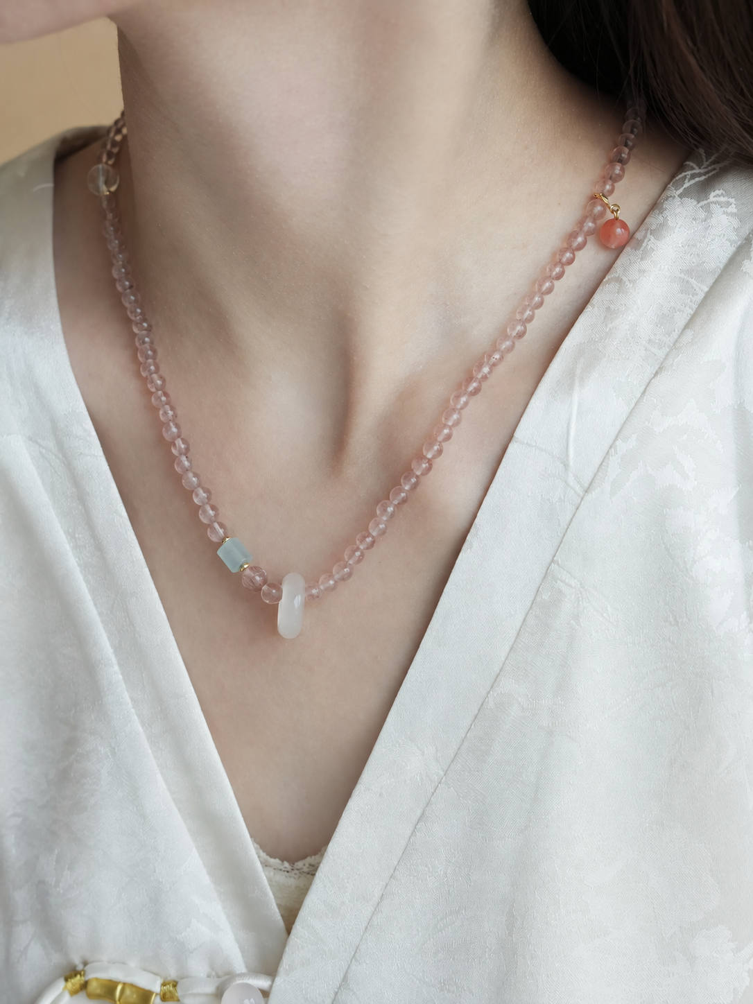 Cloud Weave strawberry quartz strand worn as a necklace