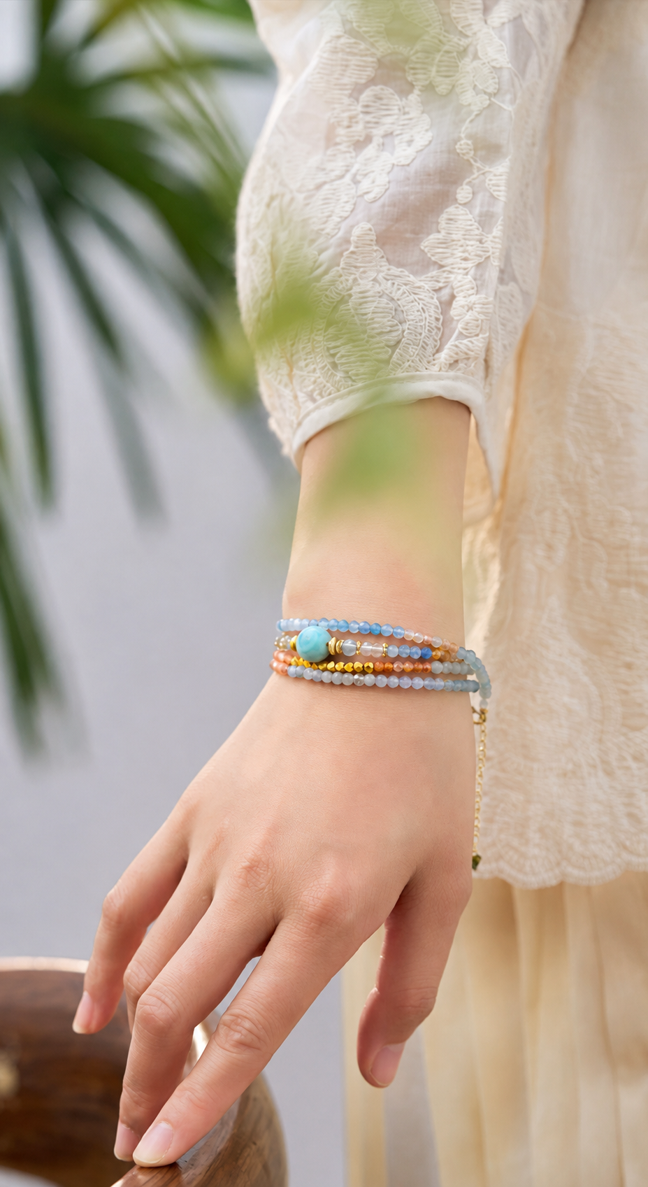 Aquamarine zodiac multi-strand bracelet worn on a model wrist