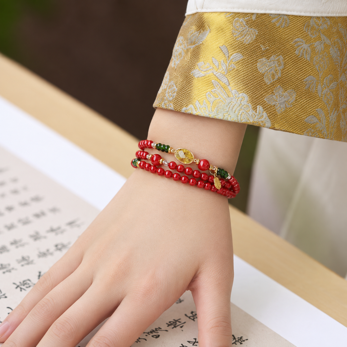 Model wearing the exact Aries red multi-wrap bracelet with translucent yellow oval focal stone