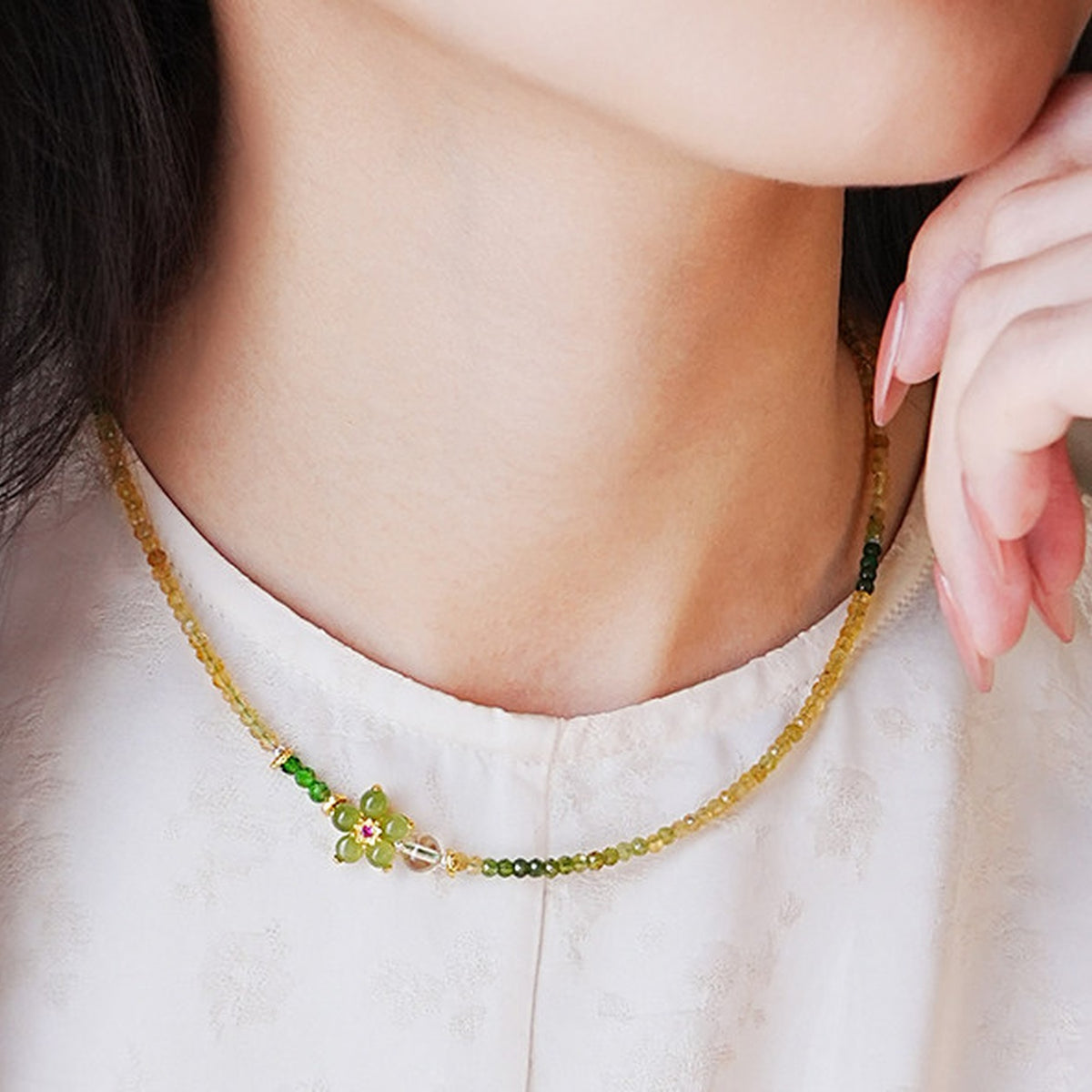 Model wearing the Verdant Bloom yellow-green gemstone necklace