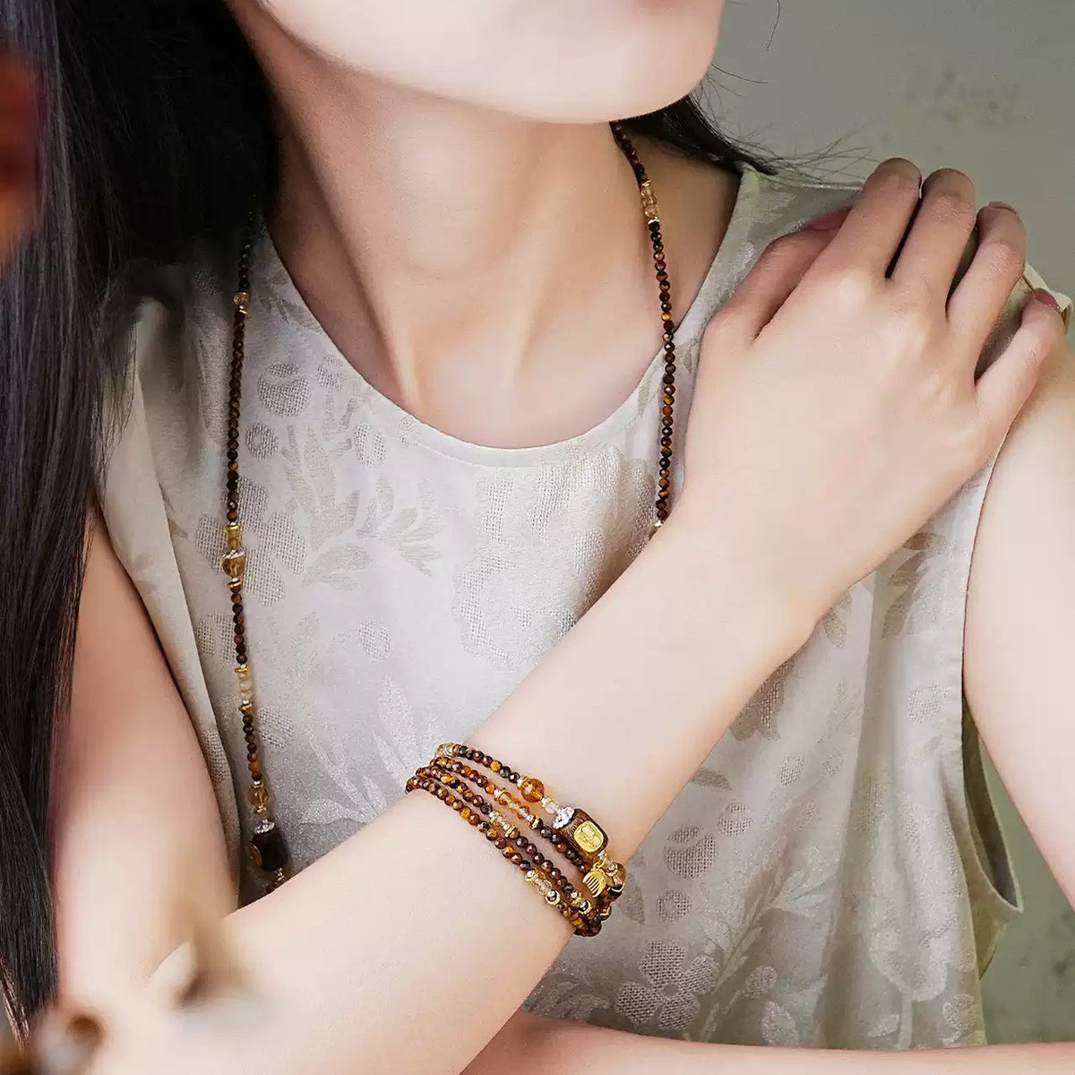 Model wearing the Annual Rings strand as a multi-wrap bracelet