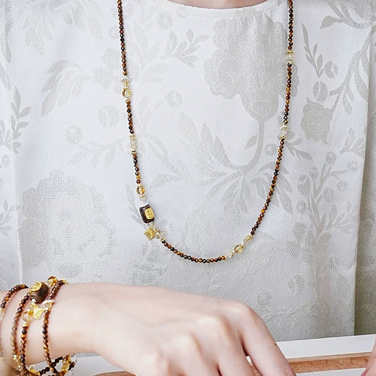 Model wearing the Annual Rings tiger's eye and agarwood necklace