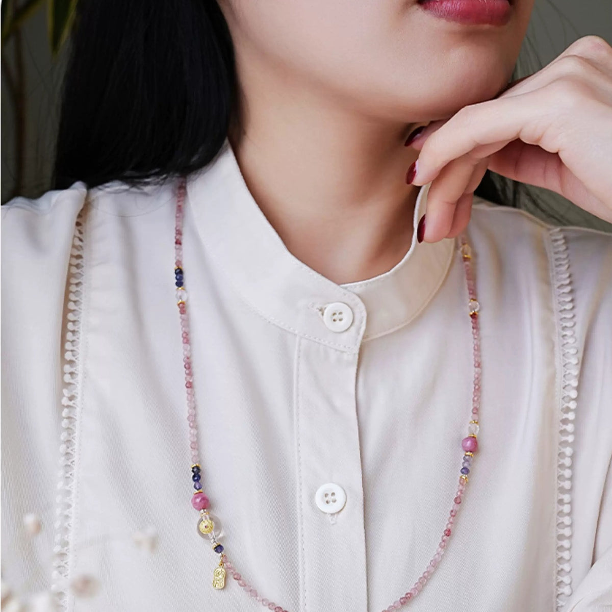 Model wearing the Peach Fortune strawberry quartz necklace