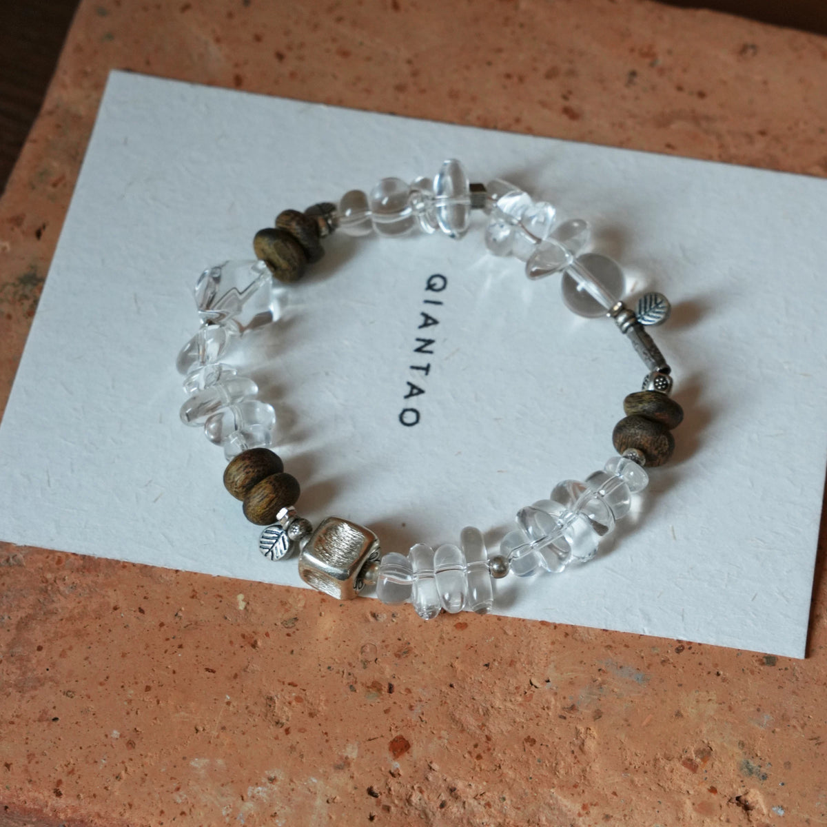 Pine clear quartz and agarwood bracelet with silver-tone cube