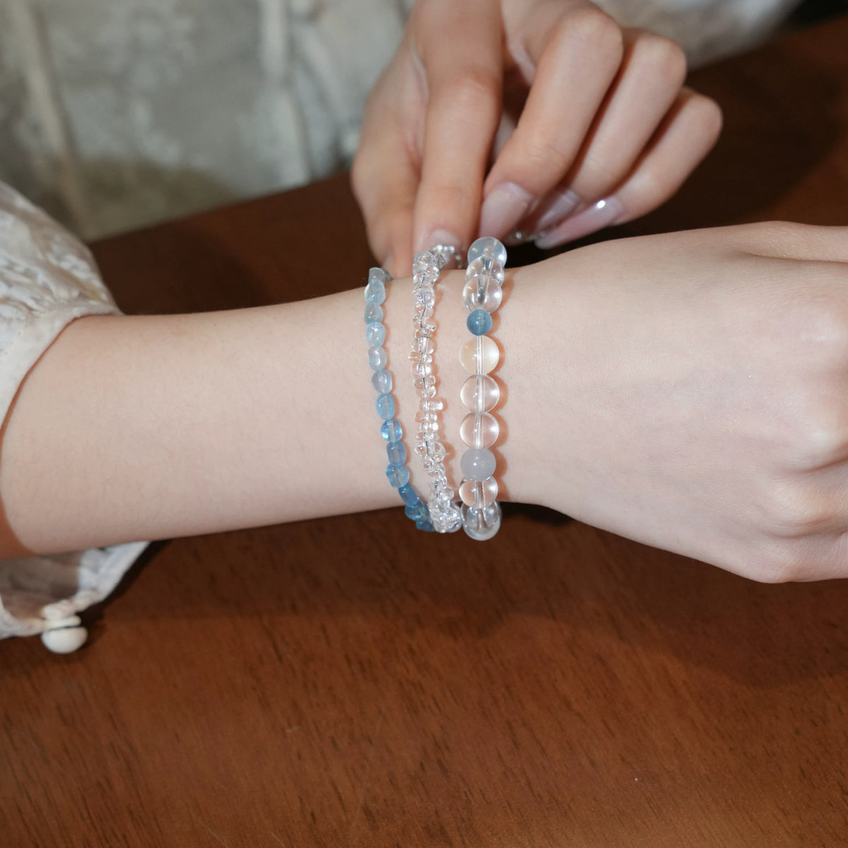 Tide crystal bracelet styled in a blue bracelet stack on the wrist