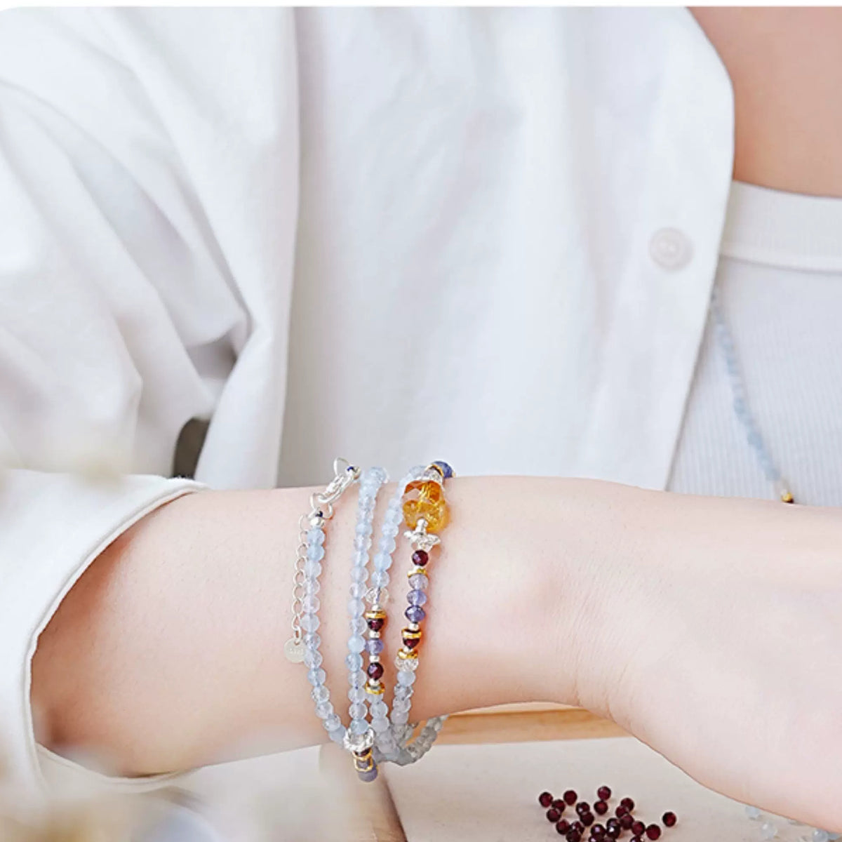 Model wearing the layered aquamarine bracelet set