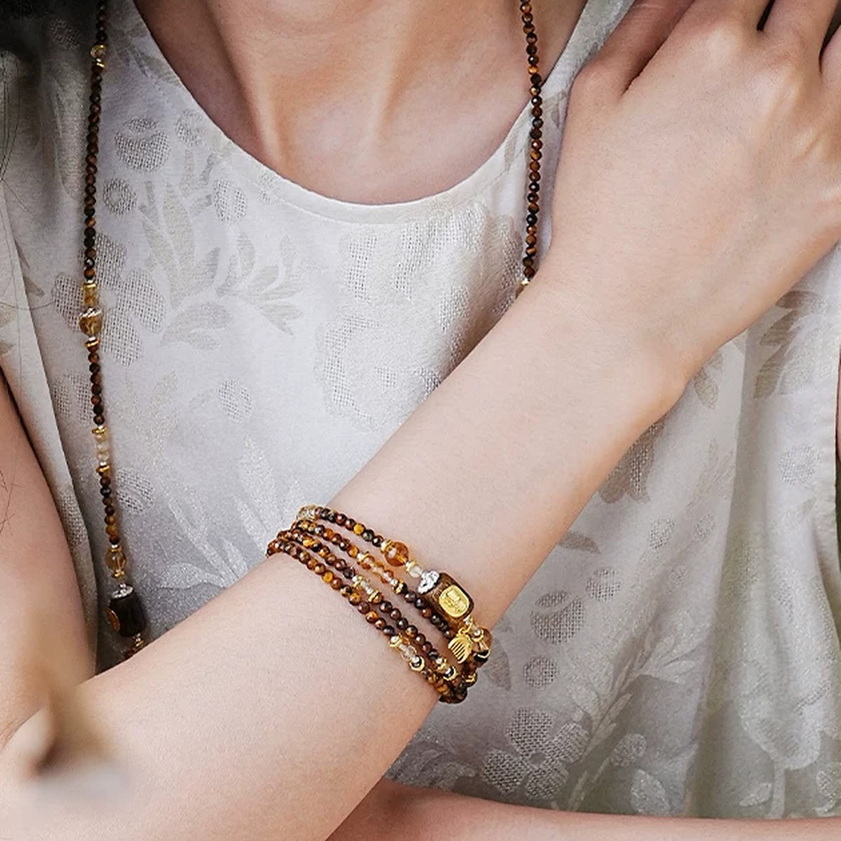 Model wearing the Annual Rings strand with zodiac inspiration