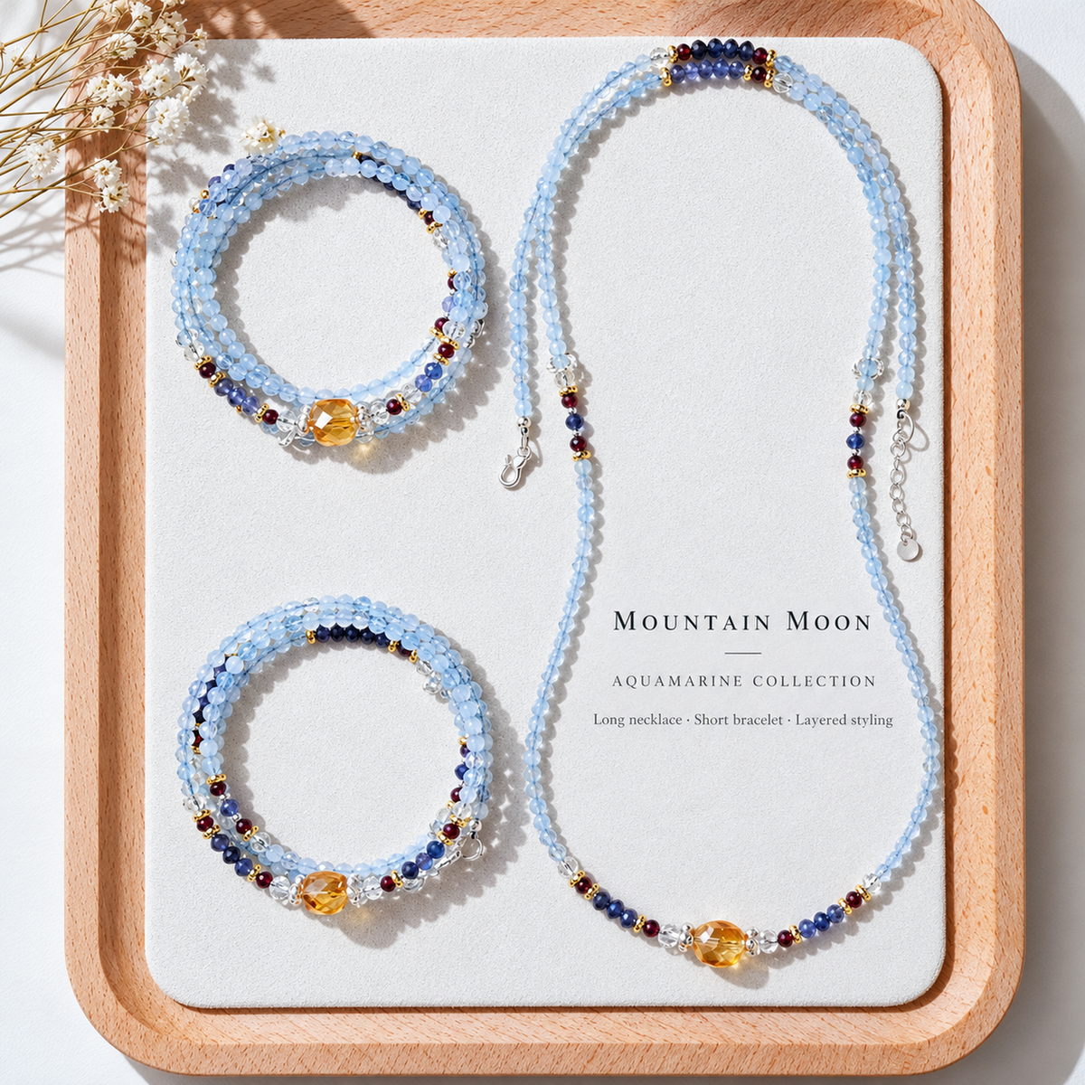 Mountain Moon aquamarine necklace and bracelets arranged on a jewelry tray